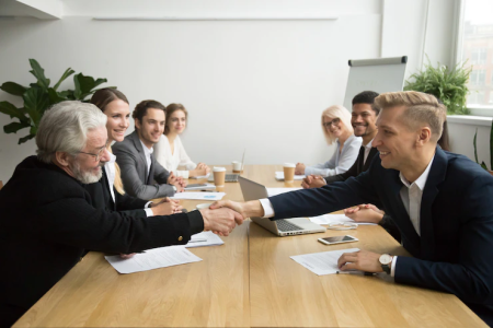 senior-investor-buying-startup-handshaking-young-entrepreneur-group-meeting_1163-4888.png